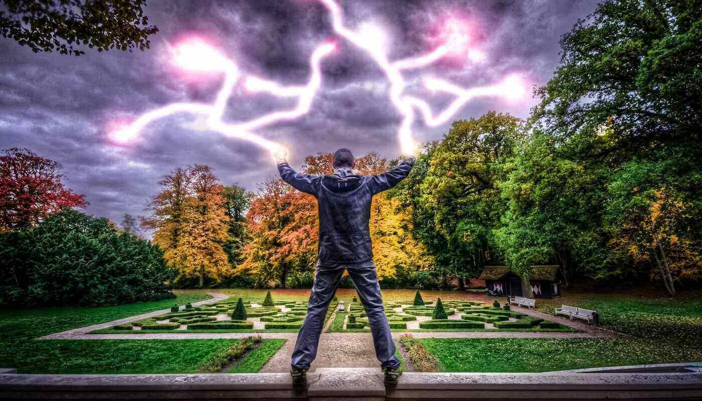 man in front of maze with lightning from fingers