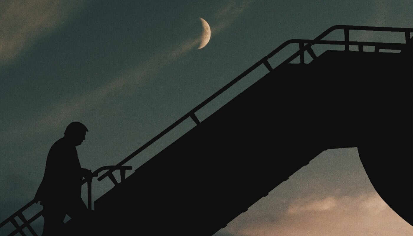 Donald Trump climbing stairs to plane