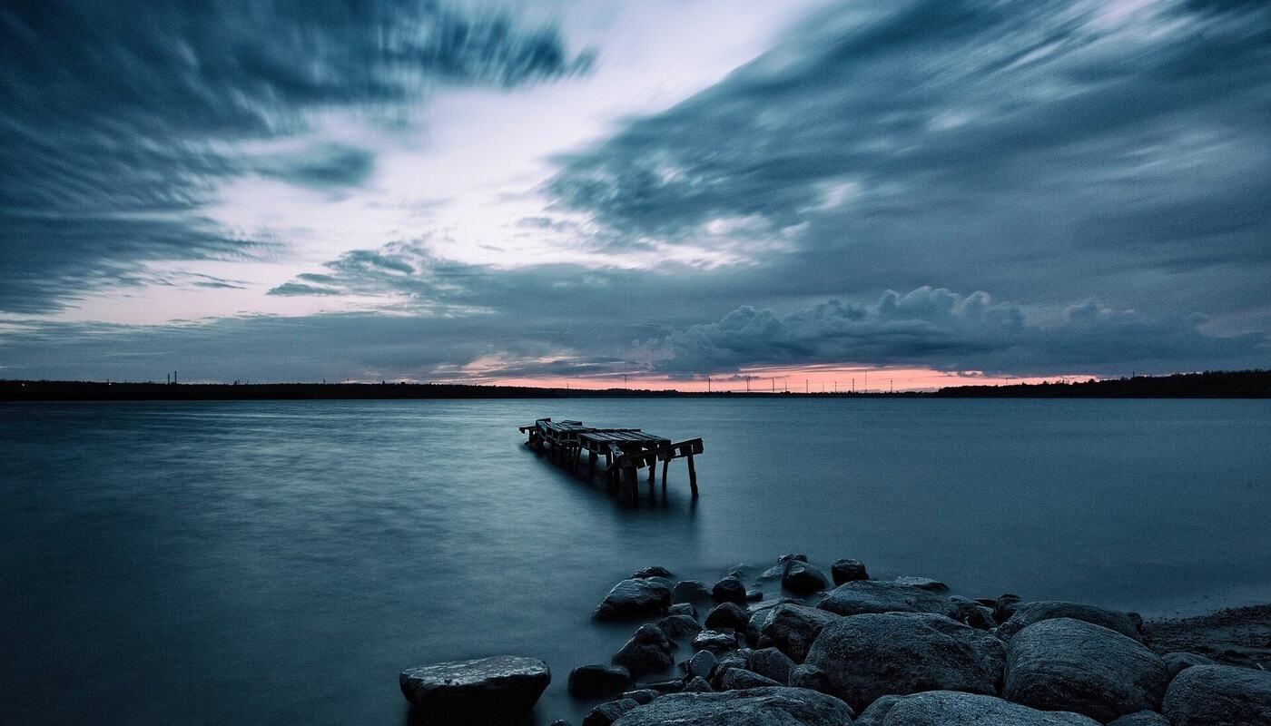 jetty on a lake at sunset