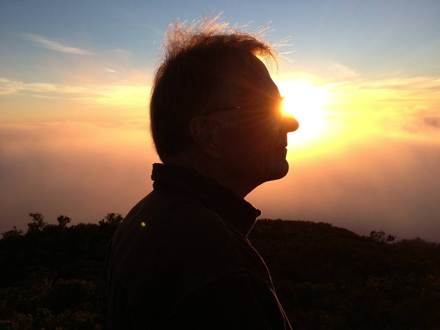 Sun shining on man's glasses