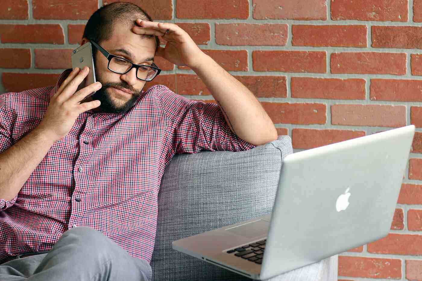 RISE UP: 7 challenges that come with being a leader 15 Frustrated businessman with laptop, on phone
