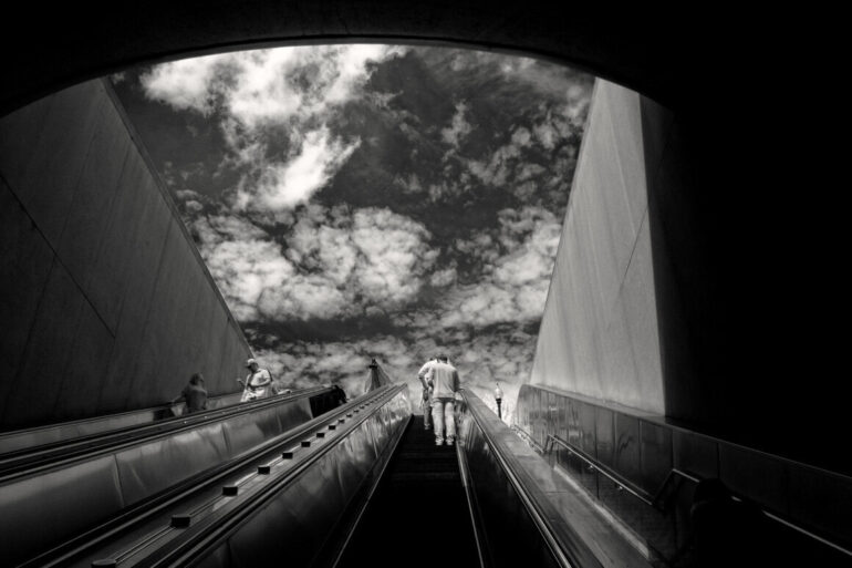 man on escalator to the sky