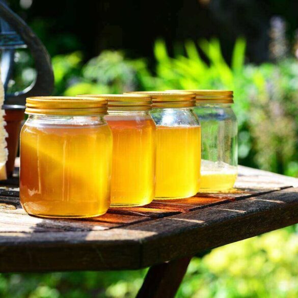 Jars of honey on outdoor table