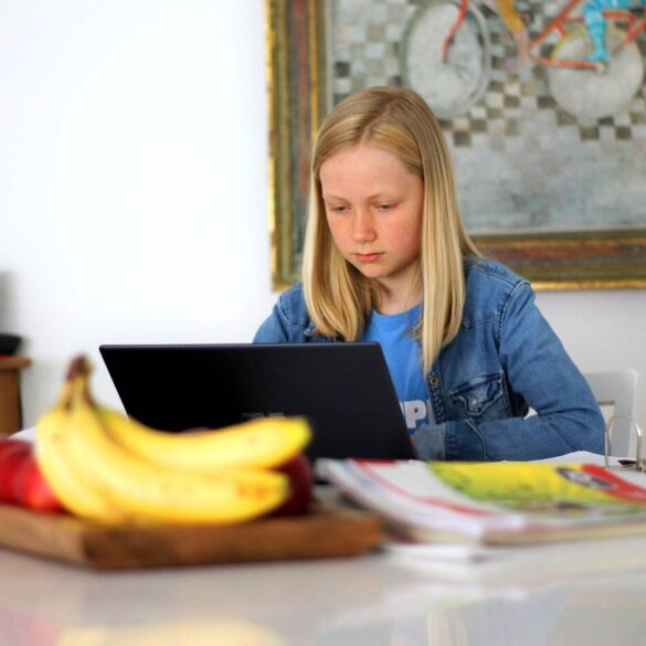 Young girl learning from home on laptop