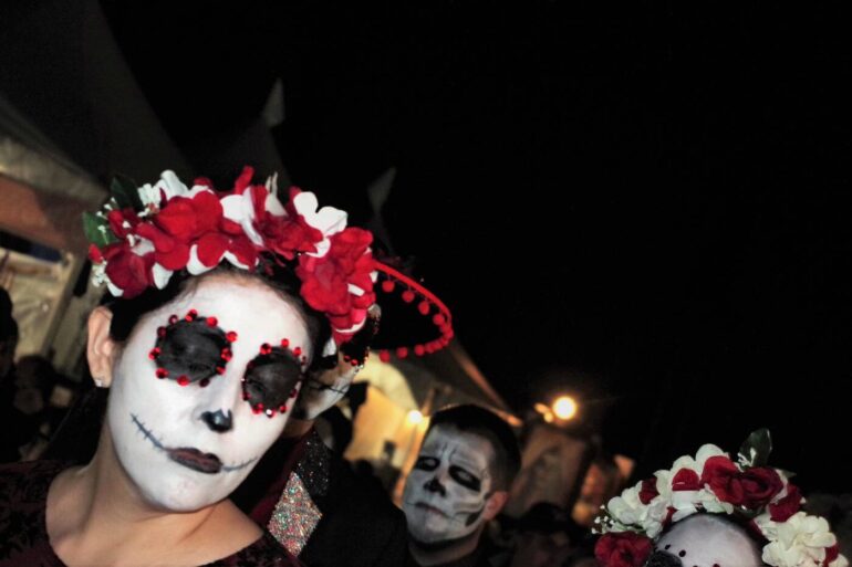 The Day of the Dead celebrators in costumes