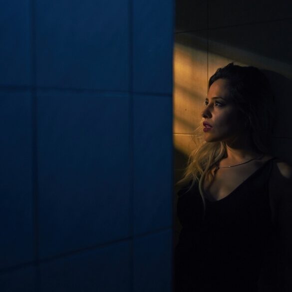 woman alone staring through a window