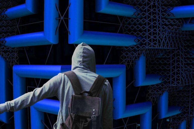 young man hitching a ride in front of a maze on a wall