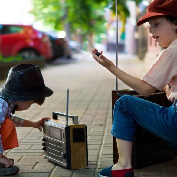 two boys playing with a radio