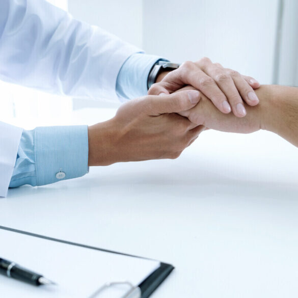 doctor holding patient's hand