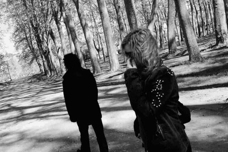 Two angry, sullen people on path