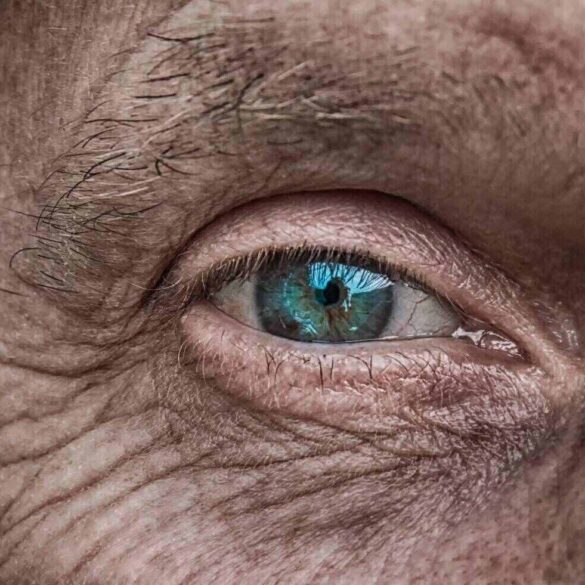 Blue eye on man's wrinkled face