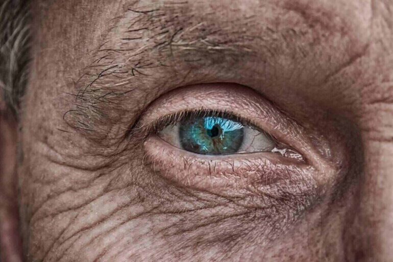 Blue eye on man's wrinkled face