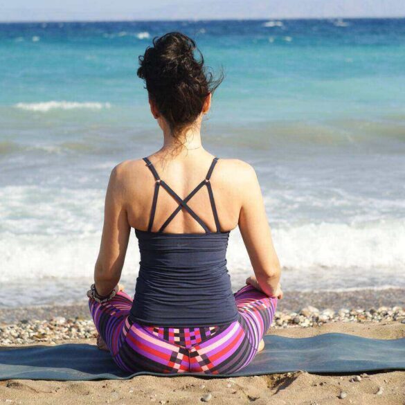 Woman meditating on beach