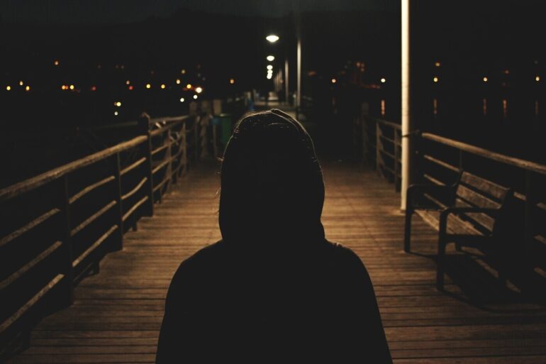 POEMS BY MIKE LARCOMBE: The No-Answer Answer, I Am the Love That I Seek, You Are Not Just You 16 Lone person walking across bridge in dark, wearing hoodie