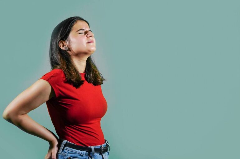 Young woman with back pain
