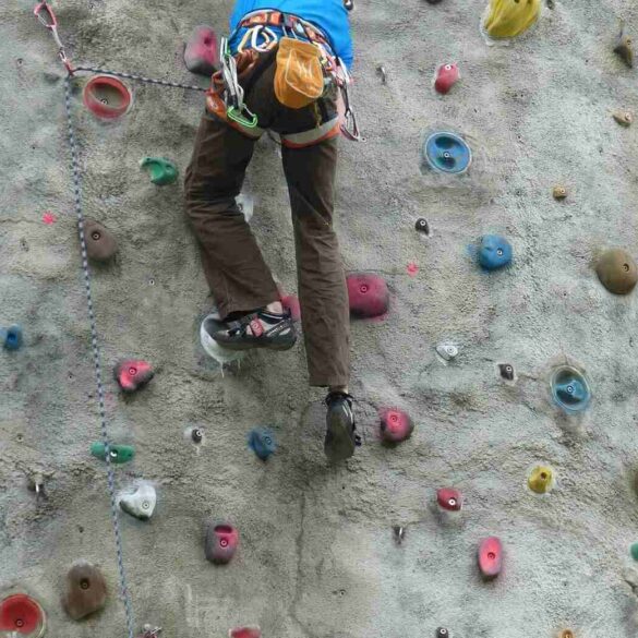 Person going up climbing wall