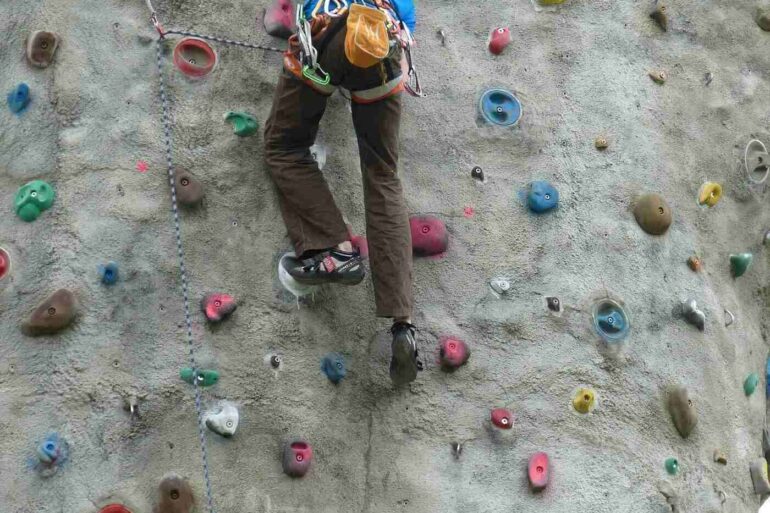 Person going up climbing wall
