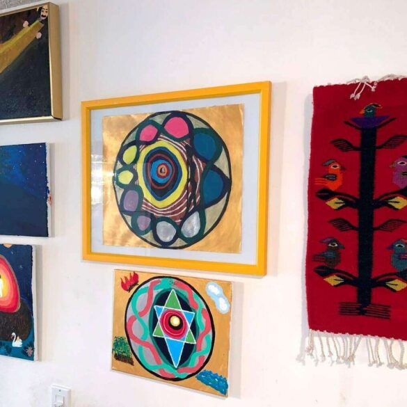 Six paintings displayed in Max Reif's hallway