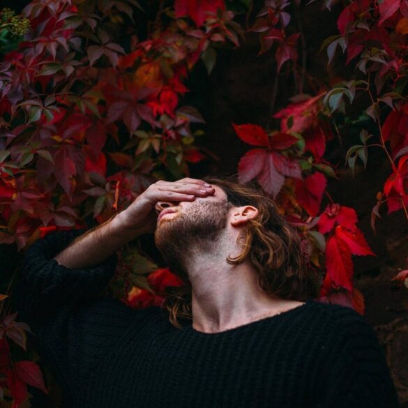 man holding his head trying to decide