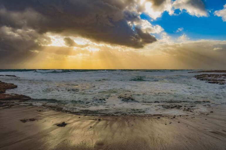 Windy beach with rain clouds overhead