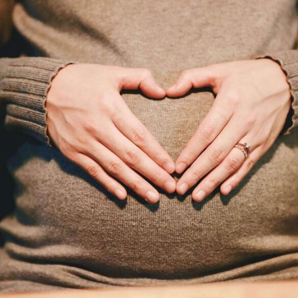 Pregnant woman with hands on belly