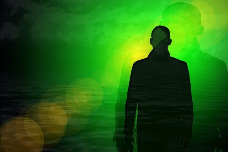 Silhouette of man, representing the soul, on green background
