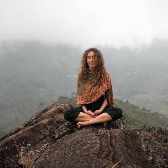 woman on hill meditating