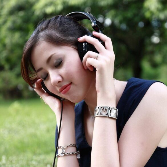 Woman listening to headphones outdoors