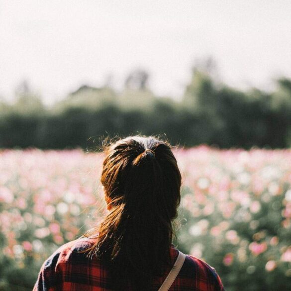 Woman looking at field of flowers