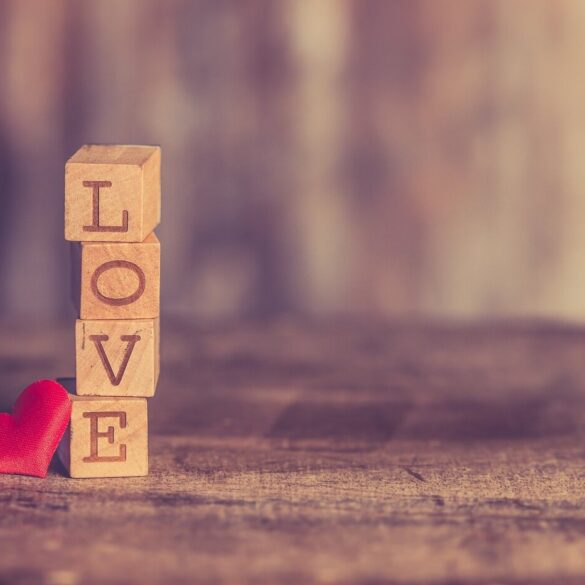 LOVE in Scrabble tiles with a heart