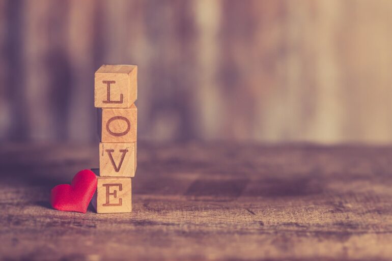 LOVE in Scrabble tiles with a heart
