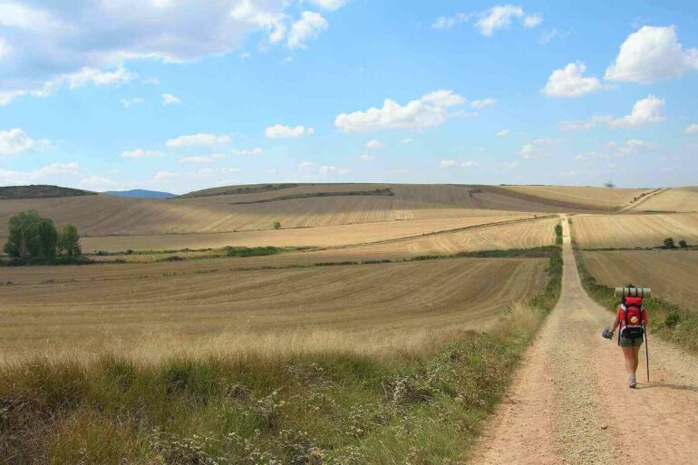 Person hiking El Camino trail in Santiago, Spain