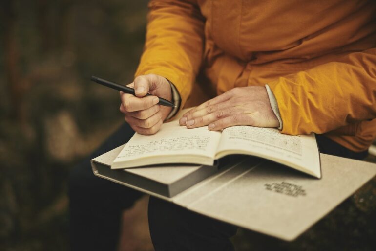 Adult journaling outdoors