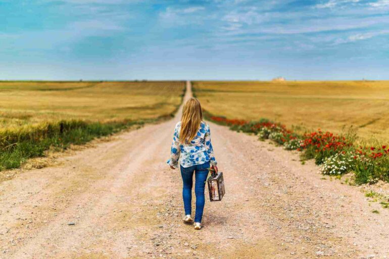 woman with suitcase leaving