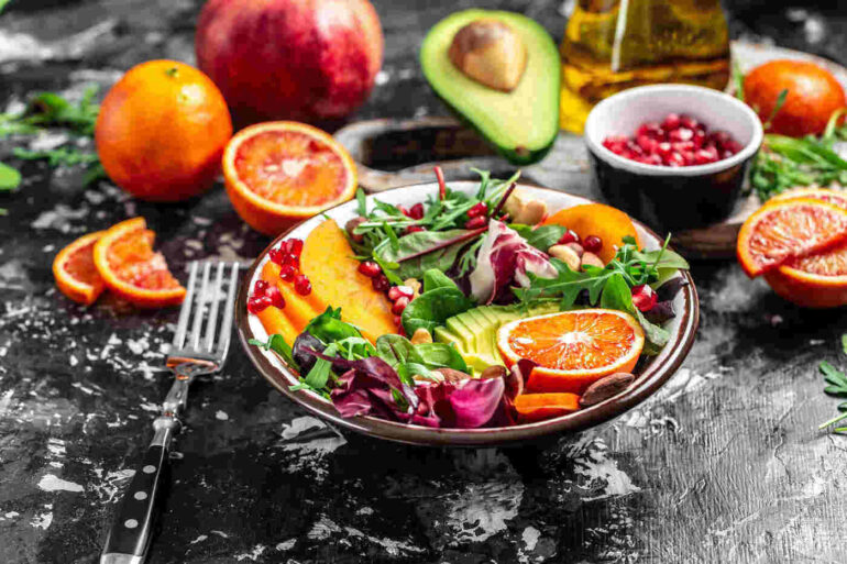 Salad with fruits and veggies on table