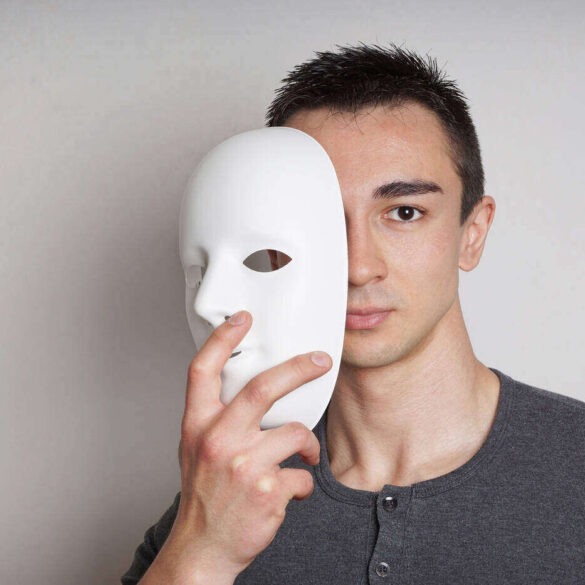 Man removing plaster mask