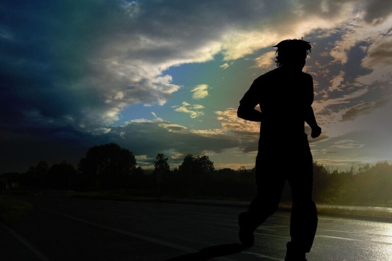 Silhouette of man running outdoors