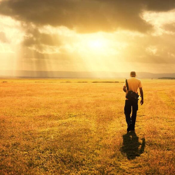 Man walking outdoors with rain cloud above