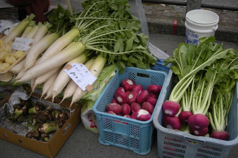 Vegetables for sale outdoors, including daikon
