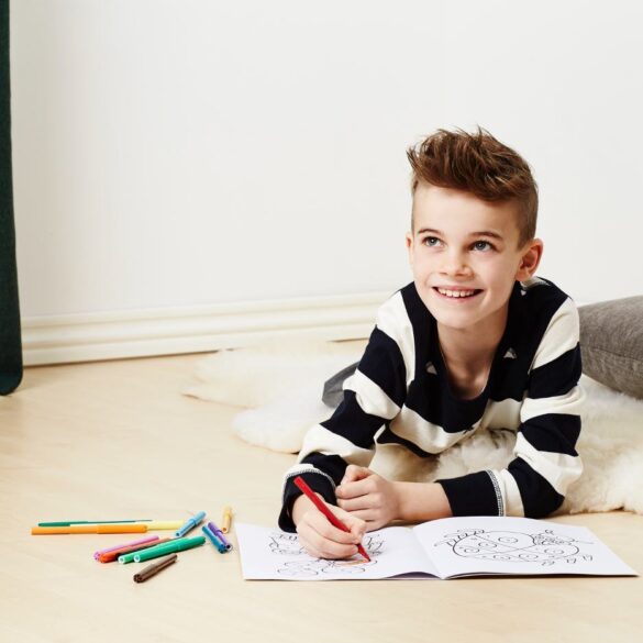 Young boy using colouring book