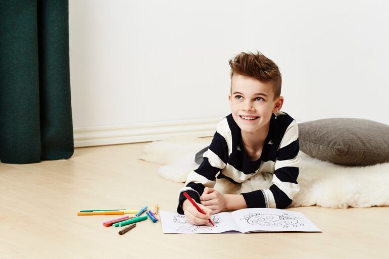 Young boy using colouring book