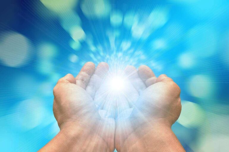 two hands holding a light