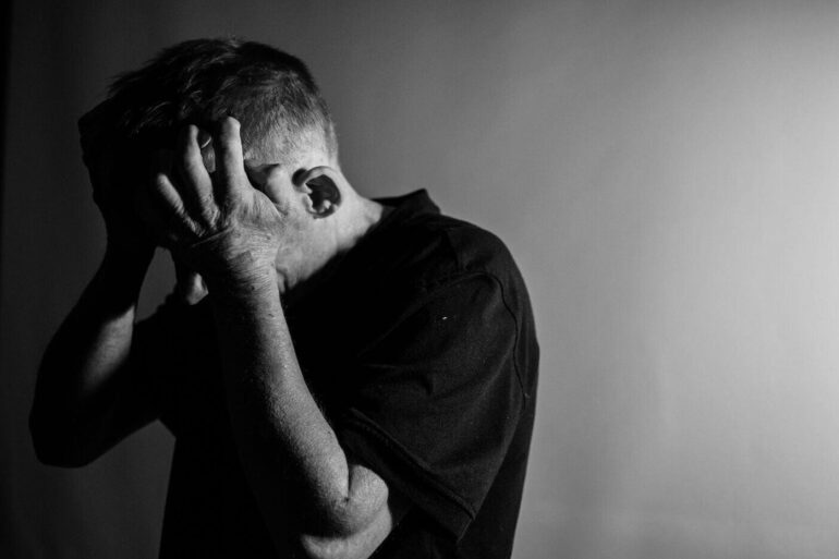 Man holding his head in despair