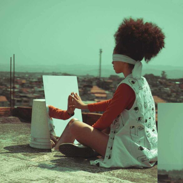 Woman blind-folded in front of a mirror