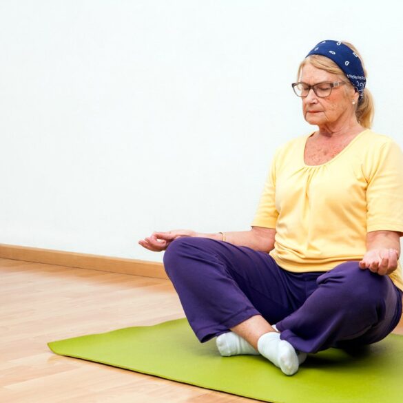 Senior woman meditating on Yoga mat - Gratitude: 3 Ways to Cultivate It While Aging Mindfully