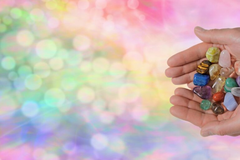 Hands holding bunch of crystals for healing