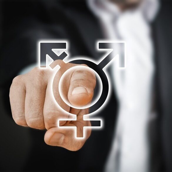 man in suit point to a 'gender' sign - Beyond the Gender Debate: A Slippery Slope of Self-Identification