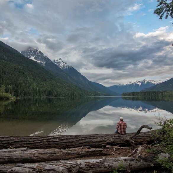 Man sitting on log beside lake - 3 Poems About Mindful Living, Including "To-Do List"