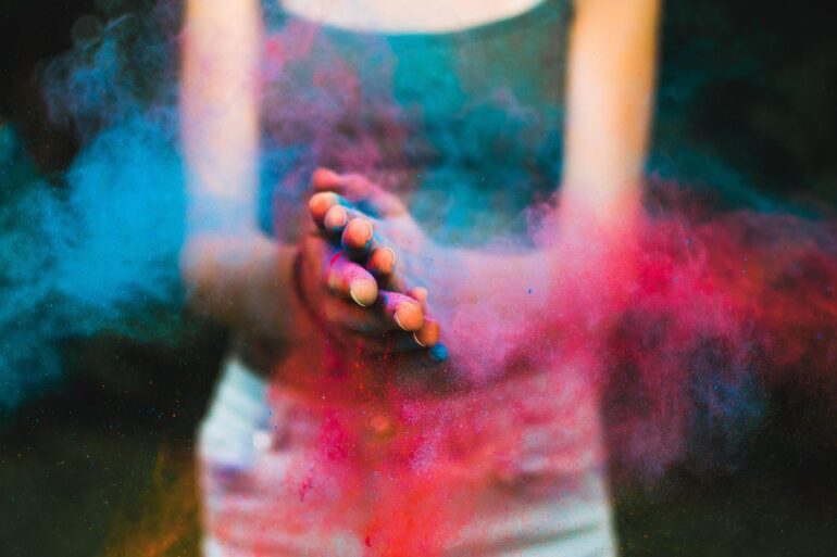 Woman clapping hands with colour coming from them - The Wonder of Creative Expression: A Gift From the Divine