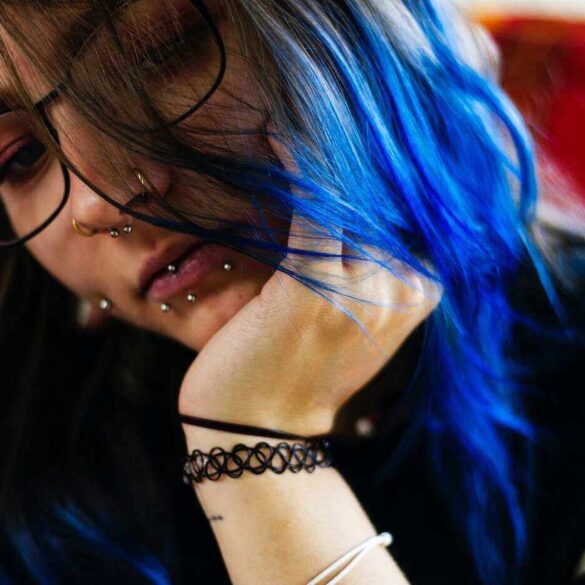 girl with blue hair and many lip piercings
